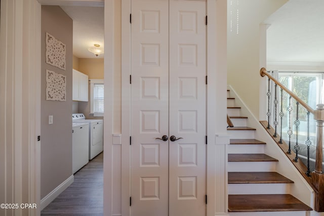 stairway with hardwood / wood-style flooring, plenty of natural light, and washing machine and clothes dryer