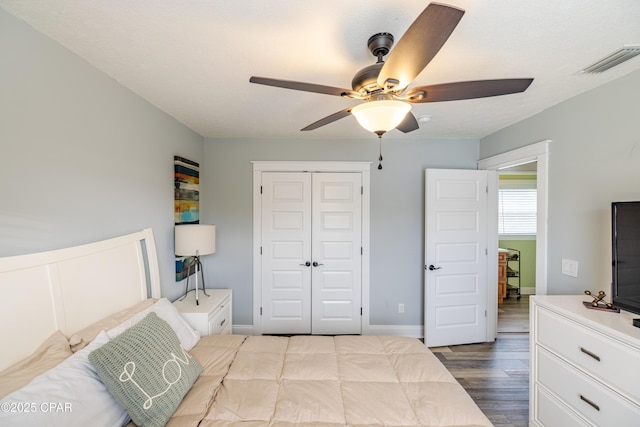 bedroom with hardwood / wood-style flooring, a closet, and ceiling fan