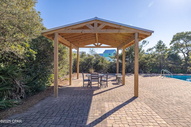 surrounding community featuring a gazebo, a swimming pool, and a patio area