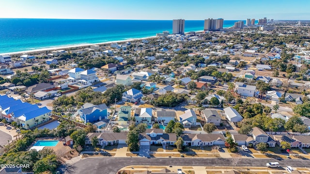 drone / aerial view with a water view and a beach view