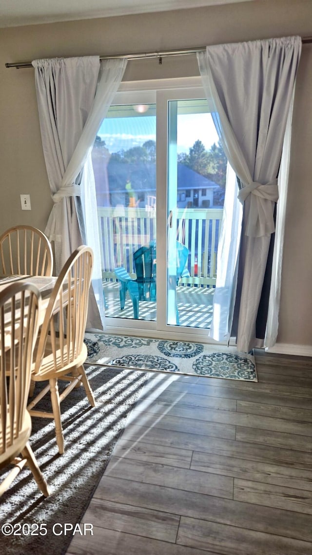 interior space featuring baseboards and wood finished floors