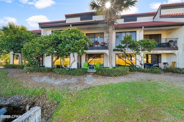 rear view of property with a lawn