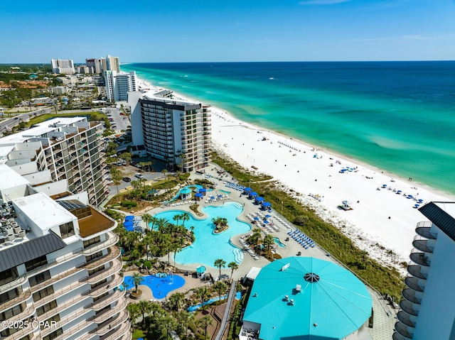 drone / aerial view featuring a beach view and a water view
