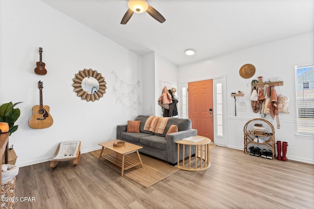 living room with ceiling fan and light hardwood / wood-style floors