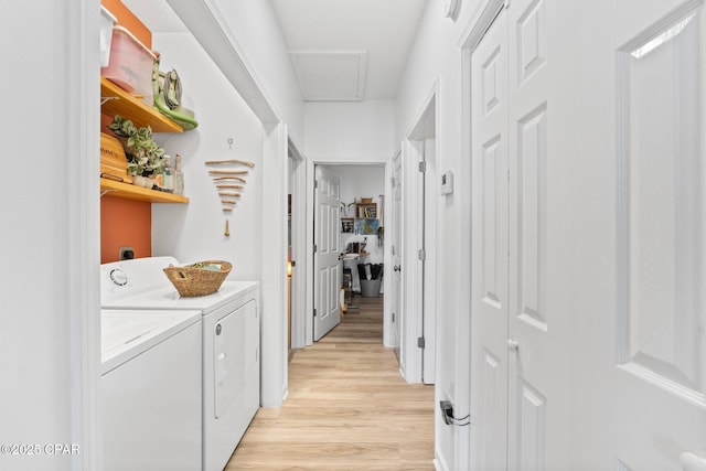 laundry room featuring washer and clothes dryer and light hardwood / wood-style floors