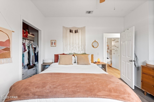 bedroom featuring hardwood / wood-style floors, a closet, and ceiling fan