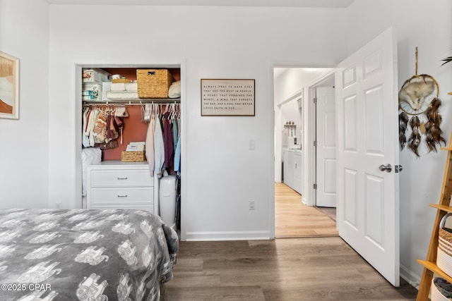 bedroom with wood-type flooring and a closet