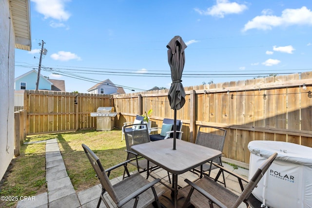 view of patio featuring a grill