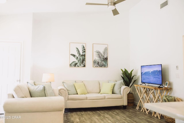 living room featuring ceiling fan and dark hardwood / wood-style flooring