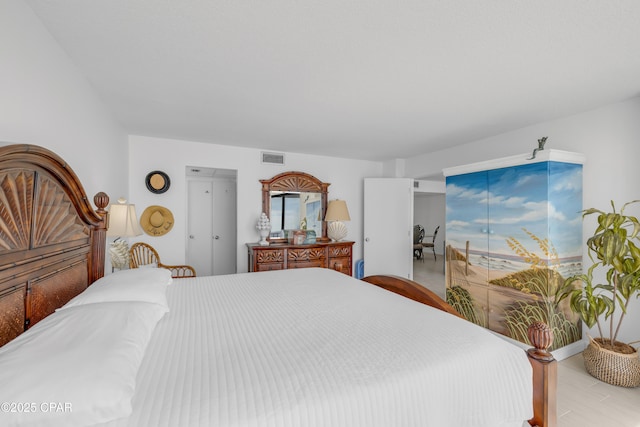 bedroom featuring wood finished floors and visible vents