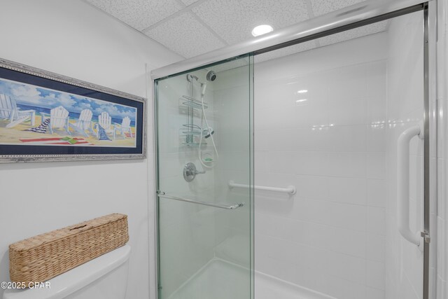 bathroom featuring a paneled ceiling, vanity, toilet, and an enclosed shower