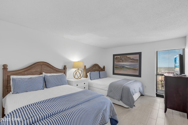 bedroom with baseboards and a textured ceiling