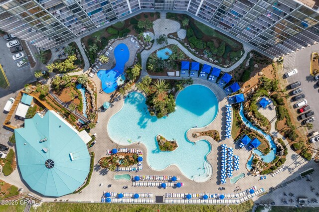 birds eye view of property featuring a water view and a beach view