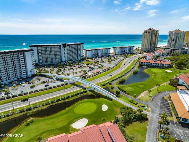 bird's eye view featuring a water view, a city view, and golf course view