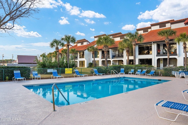 pool featuring a patio area and fence