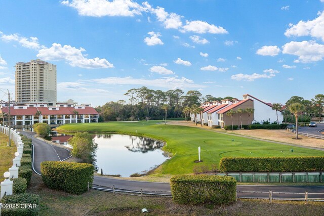 view of property's community featuring a water view and a lawn