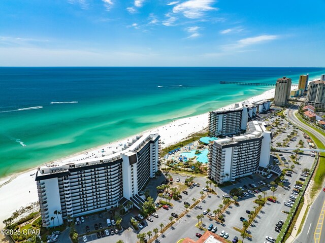 birds eye view of property featuring a water view and a beach view