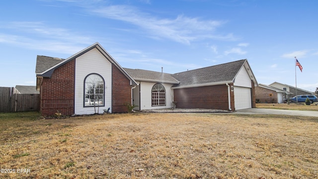 ranch-style house featuring an attached garage, fence, concrete driveway, and brick siding