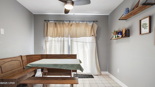 dining room with baseboards, breakfast area, ceiling fan, and light tile patterned flooring