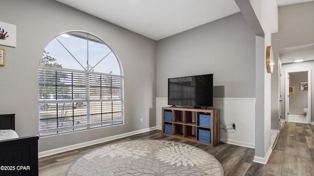 living area featuring wood finished floors and baseboards