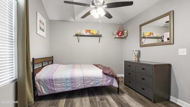 bedroom featuring ceiling fan, baseboards, and wood finished floors