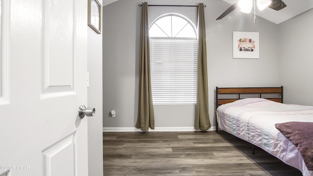 bedroom with lofted ceiling, wood finished floors, a ceiling fan, and baseboards