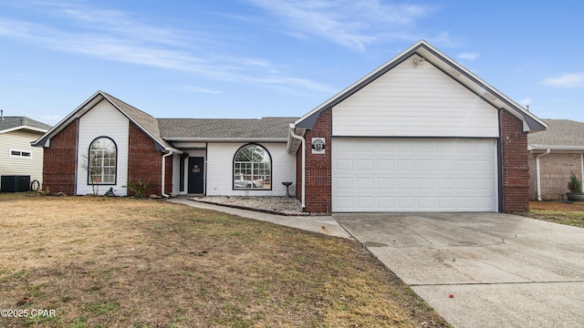 single story home featuring an attached garage, concrete driveway, central AC, and brick siding