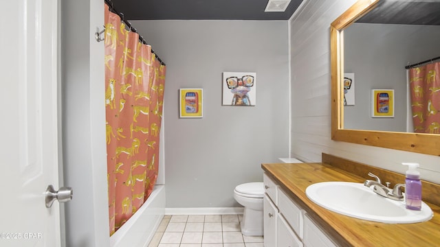 bathroom featuring tile patterned flooring, toilet, vanity, baseboards, and shower / bath combo