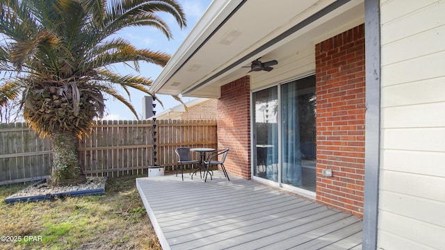 wooden deck featuring fence and a ceiling fan