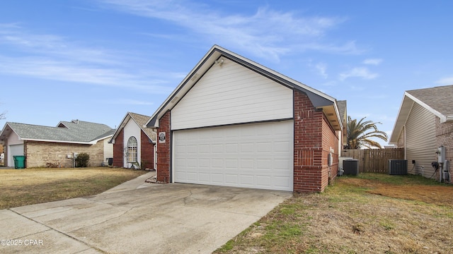 view of front of house with a garage, cooling unit, brick siding, and driveway