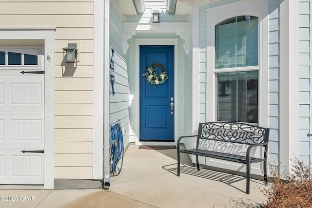 view of exterior entry featuring an attached garage