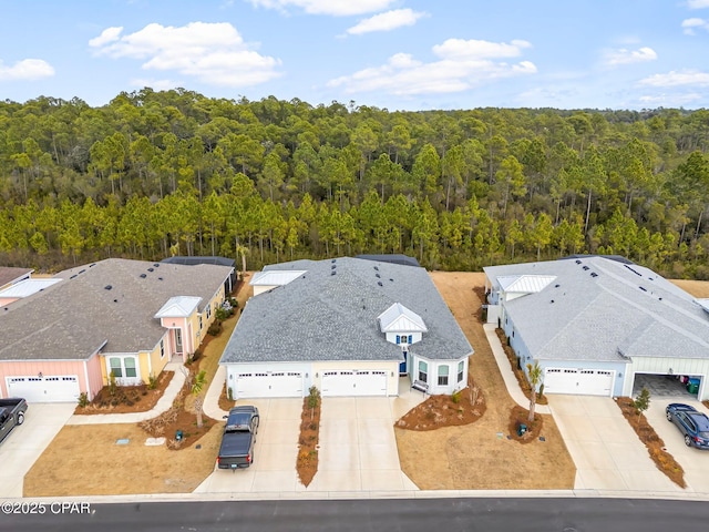 birds eye view of property featuring a wooded view