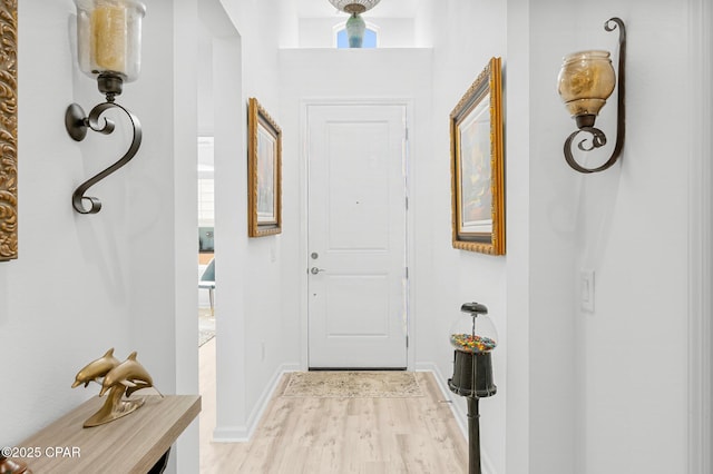 interior space with baseboards and light wood finished floors