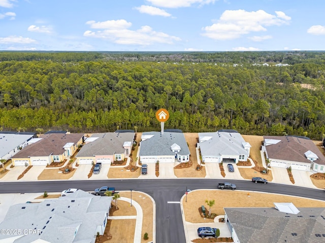 bird's eye view featuring a forest view and a residential view