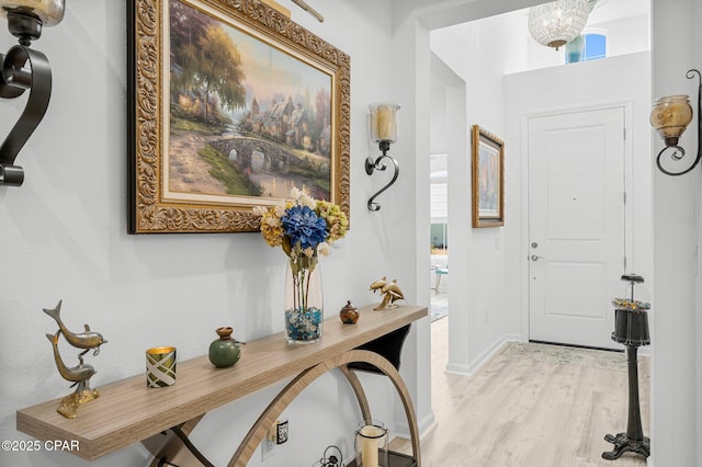 foyer with light wood-type flooring and baseboards