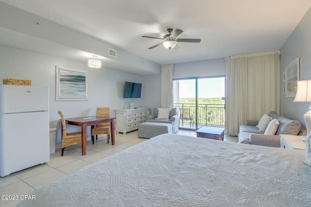 bedroom with ceiling fan, light tile patterned floors, white fridge, and access to outside