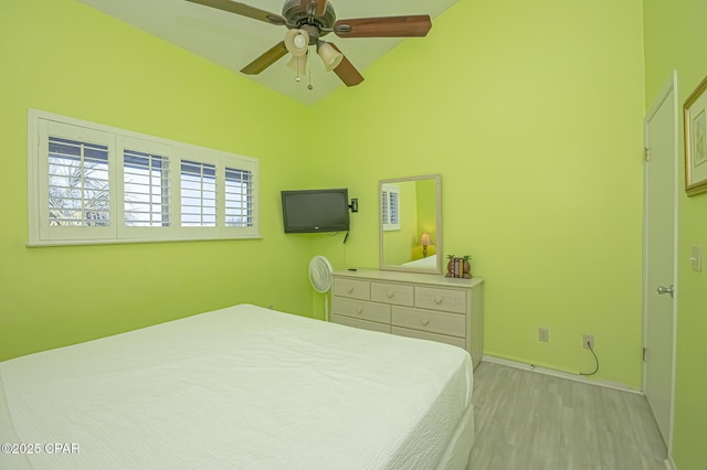 bedroom featuring ceiling fan, lofted ceiling, and light hardwood / wood-style flooring