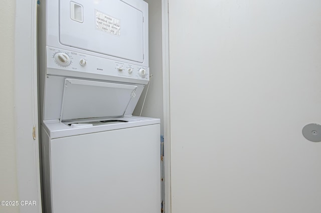 laundry room featuring stacked washer / drying machine