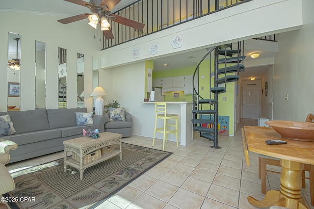 tiled living room featuring a towering ceiling and ceiling fan