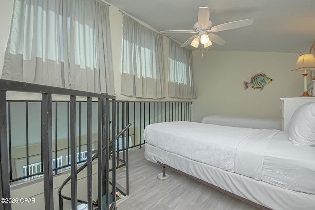 bedroom featuring hardwood / wood-style floors and ceiling fan