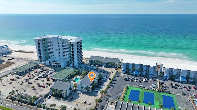 drone / aerial view featuring a water view and a beach view