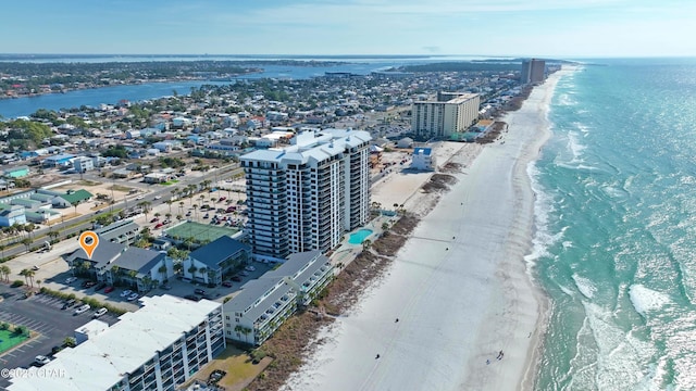 birds eye view of property with a water view and a view of the beach