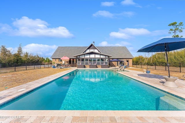 view of swimming pool featuring a patio area and an outdoor structure