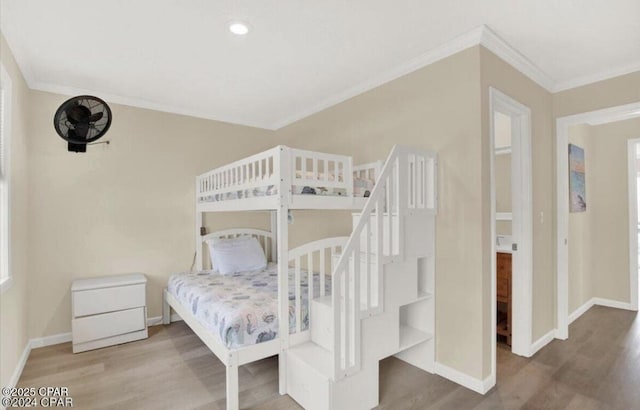 bedroom featuring recessed lighting, crown molding, baseboards, and wood finished floors