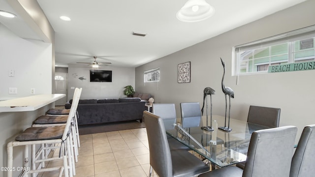 tiled dining space featuring ceiling fan