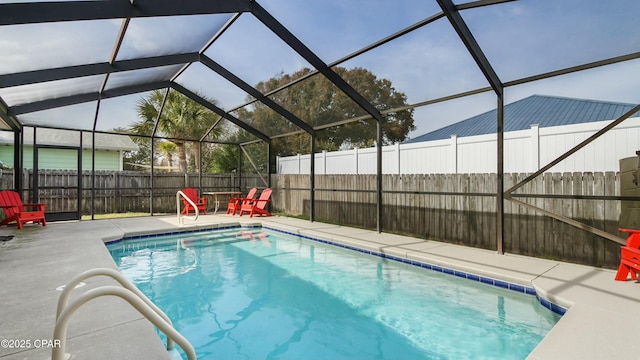 view of swimming pool featuring a patio area and glass enclosure