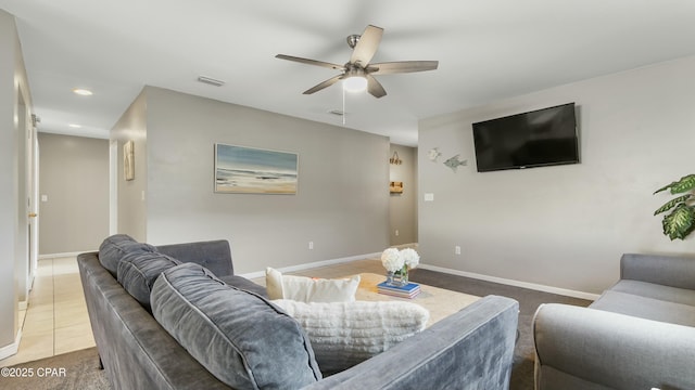 living room featuring dark tile patterned flooring and ceiling fan