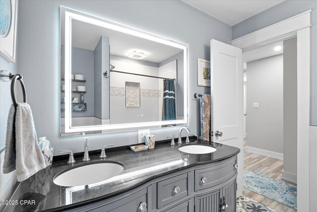 bathroom with vanity, hardwood / wood-style floors, and walk in shower