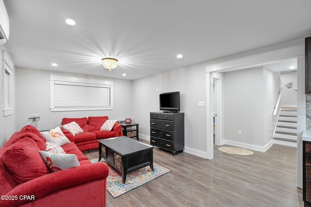 living room with wood-type flooring and a wall mounted air conditioner