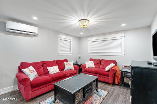 living room with hardwood / wood-style flooring and a wall mounted air conditioner